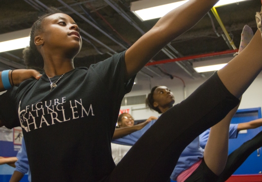 Girls in Figure Skating in Harlem practice on the locker room floor of the City Ice Pavilion.